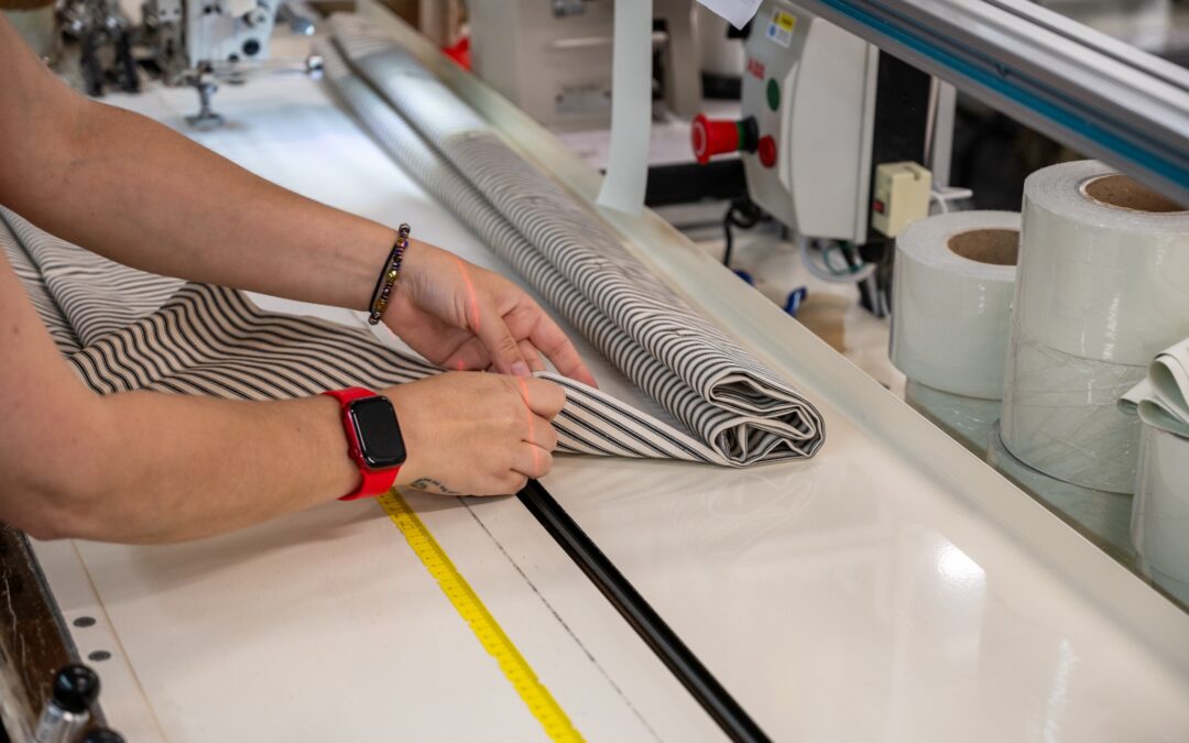 Curtain fabric being measured and folded during manufacturing