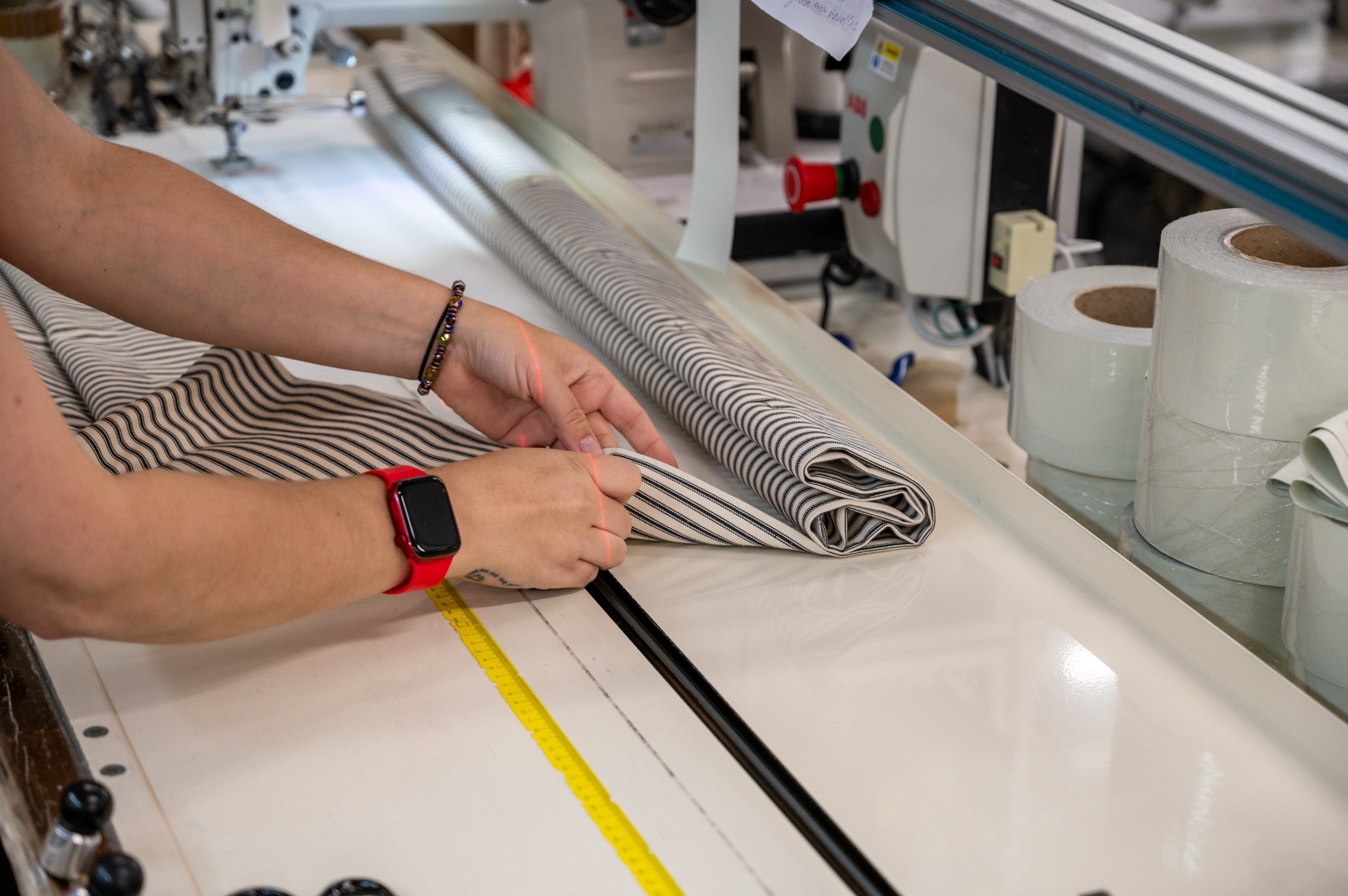 Curtain fabric being measured and folded during manufacturing